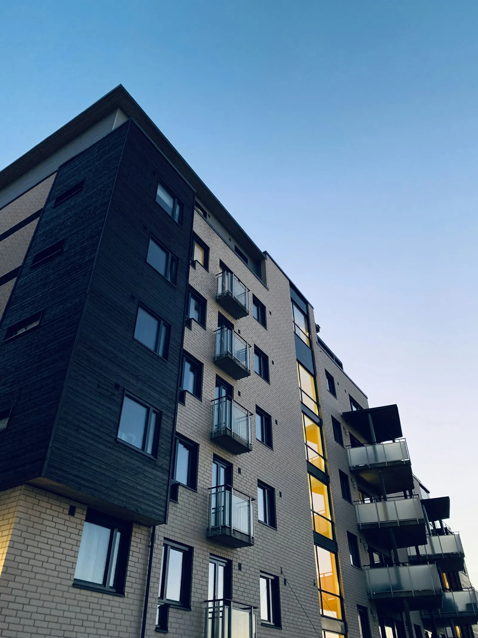 Mid-rise apartment building with balconies at dusk